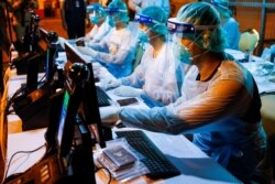 Immigration officers wearing protective suits prepare immigration for Thai nationals evacuated from China's Wuhan province, the center of the coronavirus epidemic, at the U-Tapao airport in Rayong province, Thailand, Feb. 4, 2020.