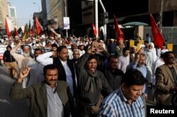 Journalists and social activists chant slogans during a rally protest which they say is against layoffs and the non-payment of salaries, in Karachi, Pakistan Feb. 8, 2019.