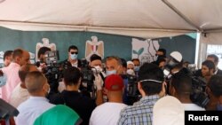 FILE - Journalists listen to Egypt's Minister of Social Solidarity Nevin el-Qabbaj at the Egyptian Food Bank, Cairo, May 2, 2020. Under President Abdel-Fattah el-Sissi, prosecutors have frequently brought vague charges against journalists and activists.