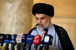 FILE - Iraqi Shi'ite cleric Muqtada al-Sadr delivers a sermon to worshippers during Eid al-Fitr prayers at the Kufa mosque near Najaf, June 5, 2019.