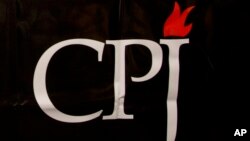 FILE - The CPJ logo is seen on a banner at a media conference in Brussels, Belgium, Sept. 29, 2015. 