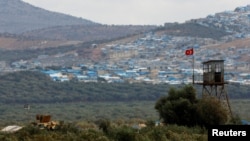 A Turkish military armored vehicle patrols on the border line located opposite the Syrian town of Atimah, Idlib province, in this picture taken from Reyhanli, Hatay province, Turkey, Oct. 10, 2017.