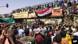 Protesters rally at a demonstration near the military headquarters in the capital Khartoum, Sudan, April 9, 2019.