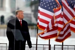 FILE - U.S. President Donald Trump looks on at the end of his speech during a rally to contest the certification of the 2020 U.S. presidential election results by the U.S. Congress, in Washington, Jan. 6, 2021.