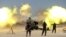 Shi'ite fighters with Iraqi security forces fire artillery during clashes with Islamic State militants near Falluja, Iraq, May 29, 2016.