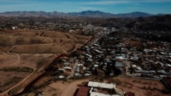 The U.S. border fence separates Nogales, Mexico, right, from sister city Nogales, Arizona, left, Jan. 3, 2020.