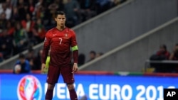 Participants row their long boats to warm up during the annual water festival on the Tonle Sap river in Phnom Penh, Cambodia.
