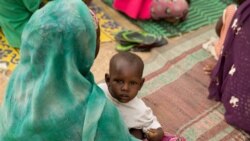 FILE: A young boy sits with a woman during a meeting with U.S. Ambassador to the United Nations Samantha Power as she speaks to people who fled to Mokolo, Cameroon, April 18, 2016, to escape Boko Haram.