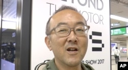 Yoh Kawakami, employee at an information management solution company, is interviewed by the Associated Press, Oct. 22, 2017, about President Donald Trump's visit to Asia in Tokyo, Japan.