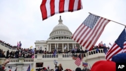 FILE - Supporters of President Donald Trump gather outside the U.S. Capitol in Washington, D.C., Jan. 6, 2021.