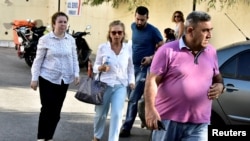Turkish journalist Nazli Ilicak (C), also a well-known commentator and former parliamentarian, is escorted by a police officer (R) and her relatives (L and rear) after being detained and brought to a hospital for a medical check in Bodrum, Turkey, July 26, 2016.