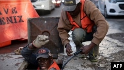 Haitian migrants work in a construction site in Mexico City, Mexico on Jan. 27, 2024. Some 141,000 people sought refuge in Mexico in 2023, a record number. Most were from Haiti, Honduras, and Cuba. They often work in the low-paid construction and commerce sectors. 