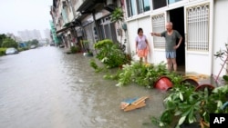 A local resident attempts to salvage a stove from the fire in the biggest Lagos wood market, Oko-Baba Sawmill, in Ebute-Metta, district of Lagos, Nigeria.