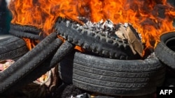 Bodies of alleged gang members covered in tires burn in the street in Petion-Ville, a suburb of Port-au-Prince, Haiti, Nov. 19, 2024. Police and civilian self-defense groups killed 28 alleged gang members in the Port-au-Prince, authorities said Tuesday,