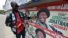 A man points to campaign posters of Nigerian President Goodluck Jonathan and candidate of the ruling People's Democratic Party (PDP) in Lagos, March 21, 2015. A man points to campaign posters of Nigerian President Goodluck Jonathan and candidate of the ruling People's Democratic Party (PDP) in Lagos, March 21, 2015. 