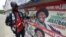 A man points to campaign posters of Nigerian President Goodluck Jonathan and candidate of the ruling People's Democratic Party (PDP) in Lagos, March 21, 2015. A man points to campaign posters of Nigerian President Goodluck Jonathan and candidate of the ruling People's Democratic Party (PDP) in Lagos, March 21, 2015. 