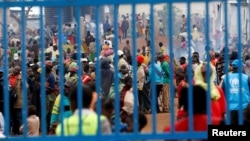 FILE - People who fled from Democratic Republic of Congo are seen gathered at the UNHCR-run Kyangwali refugee camp, in Kyangwali, Uganda, March 19, 2018.
