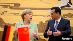 A new U.S. citizen takes a selfie with her mobile phone after taking the Oath of Allegiance during a special naturalization ceremony at the U.S. Citizenship and Immigration Services District Office in the Manhattan borough of New York City.