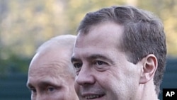Russian President Dmitry Medvedev, right, and Prime Minister Vladimir Putin walk at the presidential residence in Zavidovo, about 150 kilometers (90 miles) north of Moscow, Russia.