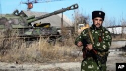 A Russian Cossack stands on guard at the military base in Perevalsk, Eastern Ukraine, Nov. 5, 2014.