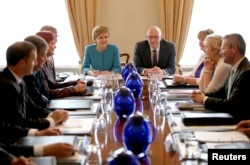 Scotland's First Minister Nicola Sturgeon (centre L) and Deputy First Minister John Swinney (centre R) attend an emergency cabinet meeting at Bute House in Edinburgh, Scotland, June 25, 2016.