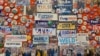 FILE - Campaign slogans, buttons, stickers and memorabilia of U.S. presidential candidates, past and present, some autographed, decorate a walls of the visitor center at the State House in Concord, New Hampshire, Feb. 3, 2020.