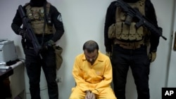 FILE - Abu Hareth, an Iraqi Islamic State preacher who owned Yazidi slaves, is seen under guard by Iraqi special forces before an interview, in Baghdad, Iraq, Aug. 28, 2019. 
