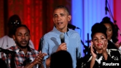 U.S. President Barack Obama speaks between Janelle Monae (R) and Kendrick Lamar during the Independence Day celebration at the White House in Washington U.S., July 4, 2016.