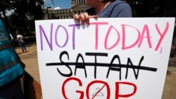 FILE - In this May 21, 2019, file photo, an abortion rights advocate holds signage at the Capitol in Jackson, Miss.