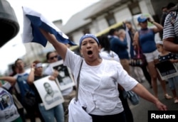 A Nicaraguan living in Costa Rica takes part in a protest in front of the Nicaraguan Embassy in San Jose, Costa Rica, Feb. 27, 2019, against the talks Nicaraguan President Daniel Ortega will resume with the leaders of the opposition.