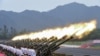 FILE - Paramilitary policemen and members of a gun salute team fire cannons during a training session for a military parade to mark the 70th anniversary of the end of the World War II, at a military base in Beijing, China. China is now the world’s third largest arms exporter behind the U.S. and Russia, and the country accounted for nearly six percent of arms exports between 2011 and 2015.