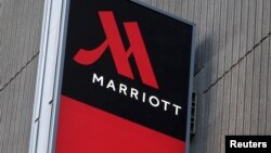 FILE - Signage for the New York Marriott Marquis is seen in Manhattan, New York, Nov. 16, 2015. Marriott International bought Starwood Hotels and Resorts for $13.6 billion on Monday to create the world's biggest hotel chain. 
