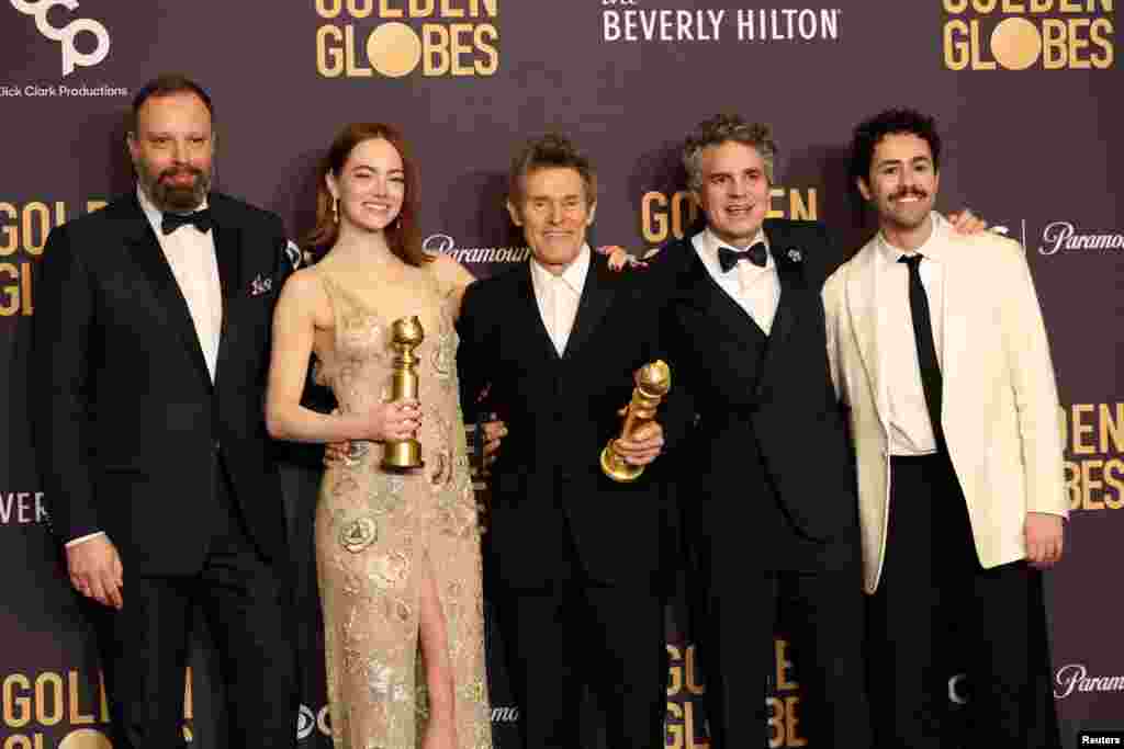 Yorgos Lanthimos, Emma Stone, Willem Dafoe, Mark Ruffalo and Ramy Youssef pose with the award for Best Motion Picture - Musical or Comedy award for "Poor Things", and Best Performance by a Female Actor in a Motion Picture - Musical or Comedy for "Poor Things", at the 81st Annual Golden Globe Awards Jan. 7, 2024.