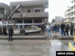 FILE - People in Qamishli, Syria, survey the damage from an explosion, April 11, 2016.