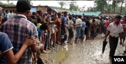 Rohingya refugees line up for water at a refugee camp near Cox’s Bazaar, Bangladesh.