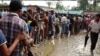 Rohingya refugees line up for water at a refugee camp near Cox’s Bazaar, Bangladesh. 