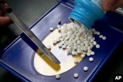 FILE - A prescription is filled at a pharmacy in Sacramento, Calif.