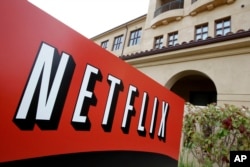 FILE - A sign points to Netfilx headquarters in Los Gatos, California.