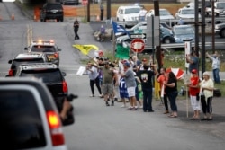 Supporters of President Donald Trump jeer the motorcade of Democratic presidential candidate, Joe Biden as it passes by, July 9, 2020, in Dunmore, Pa.