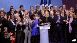 Far-right leader presidential candidate Marine Le Pen, center, stands among party officials at the end of a conference in Lyon, France, Sunday, Feb. 5, 2017.