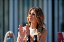 First Lady Melania Trump visits an exhibit of artwork by young Americans in celebration of the 100th anniversary of the 19th amendment, which afforded the vote to women, at the White House in Washington, August 24, 2020.
