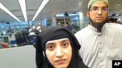 This July 27, 2014, photo provided by U.S. Customs and Border Protection shows Tashfeen Malik, left, and Syed Farook, as they passed through O'Hare Airport in Chicago. U.S. law enforcement is trying to gain access to information contained in Farook's iPhone.