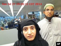 This July 27, 2014 photo provided by U.S. Customs and Border Protection shows Tashfeen Malik, left, and Syed Farook, as they passed through O'Hare International Airport in Chicago.