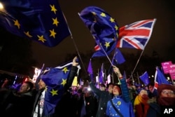 Anti-Brexit demonstrators react after the results of the vote on British Prime Minister Theresa May's Brexit deal were announced in Parliament square in London, Jan. 15, 2019.