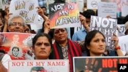 Participants hold placards during a protest against a spate of violent attacks across the country targeting the country's Muslim minority, in Bangalore, India, June 28, 2017. 