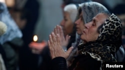 Iraqi Christians attend a Mass on Christmas eve at the Mar Shimoni church in the town of Bartella, east of Mosul, Dec. 24, 2016.