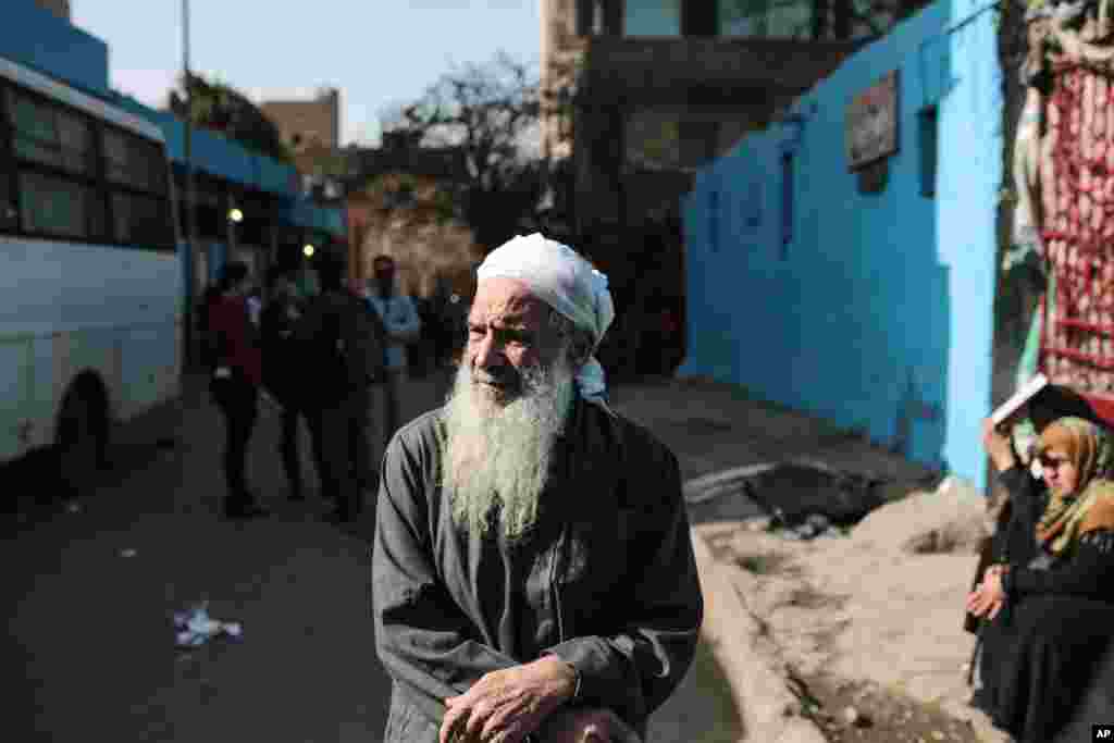 Egyptian friends and relatives of soccer fans who were killed in a riot on Sunday wait outside Zeinhom morgue, in Cairo, Feb. 9, 2015.