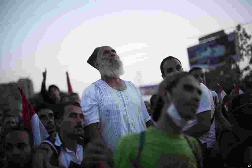 A supporter of Egypt's ousted President Mohamed Morsi listens to a speech at the main stage in the sit-in at Rabaa Al-Adawiya mosque, Cairo, August 12, 2013.