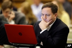 Missouri Secretary of State Jay Ashcroft looks at notes during a voter registration meeting at the the National Association of Secretaries of State conference in Indianapolis, July 8, 2017.