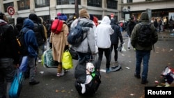 Migrants as they transfer to reception centers across the country during the dismantlement of makeshift camps, Stalingrad metro station, Paris, France, Nov. 4, 2016.